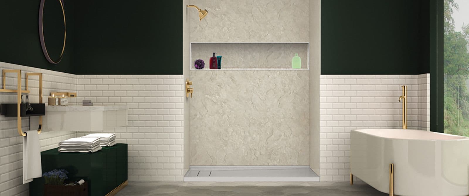A dark green and white tiled bathroom with a walk-in shower with gold fixtures and built-in caddy shelf.
