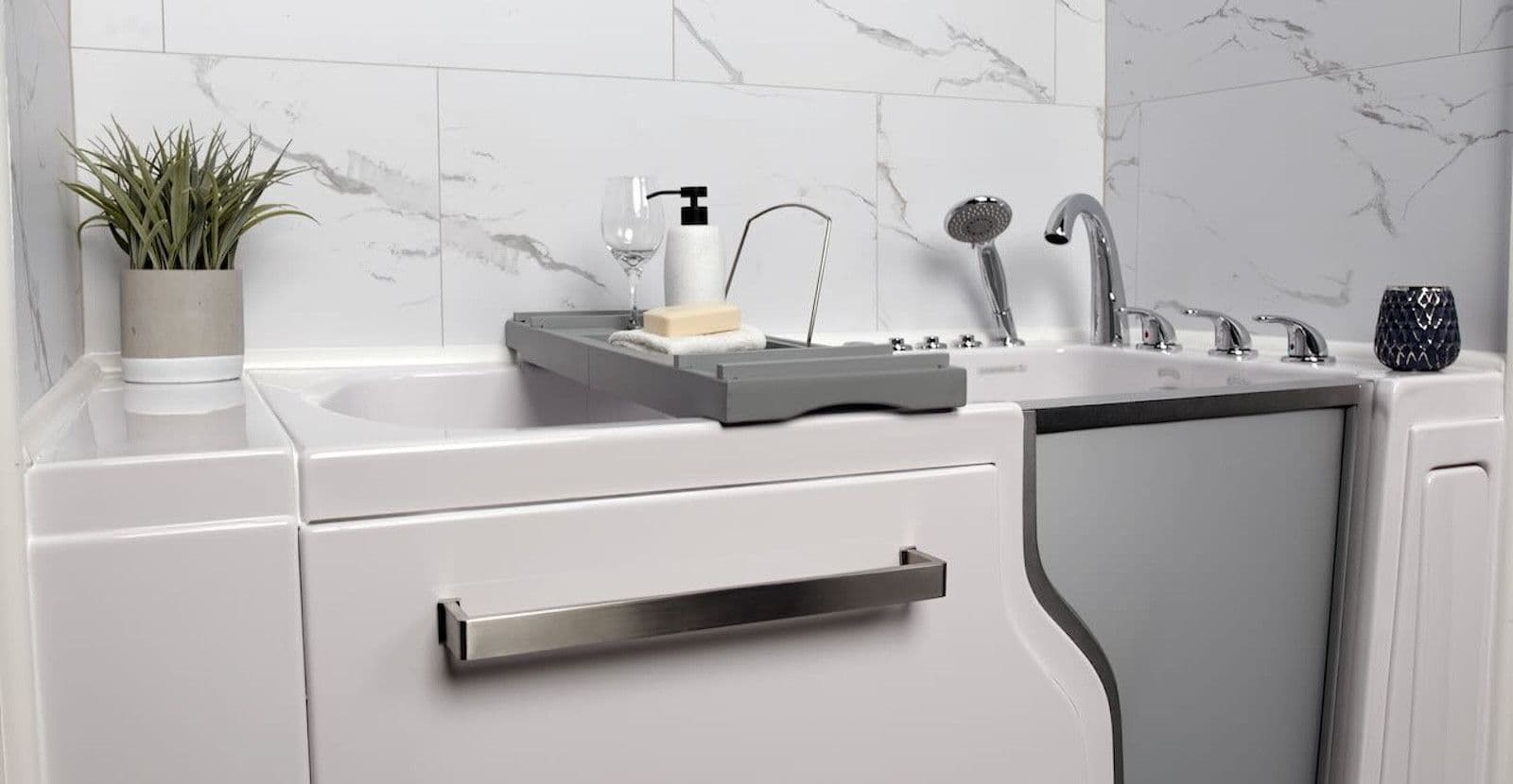 A walk-in bathtub with white marble-patterned walls.